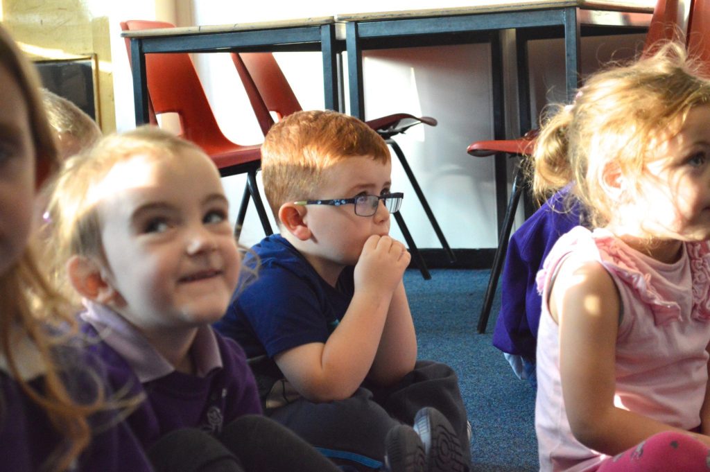 A young pupil listens attentively to a story.
