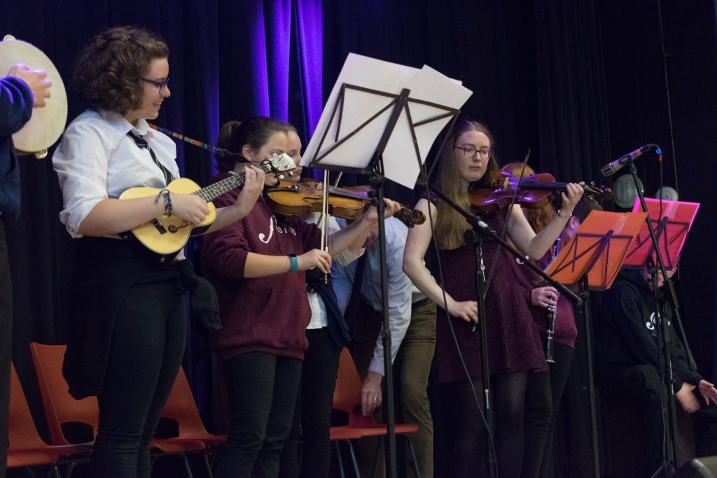 Musicians from Banff Academy's Trad Band perform on stage.