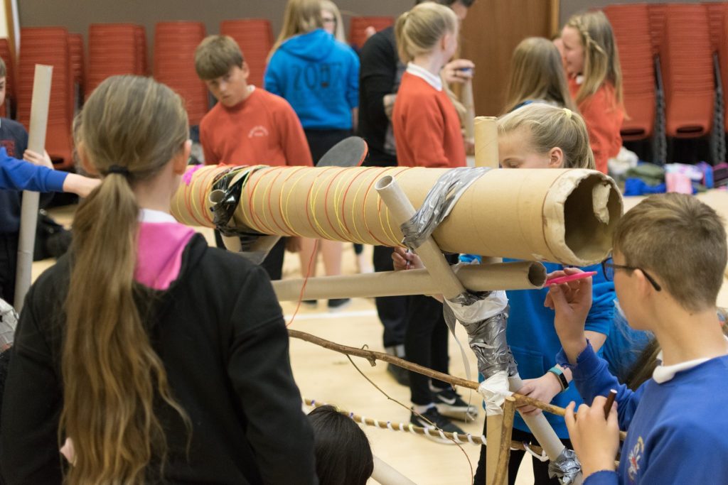 Pupils create their own musical instruments.